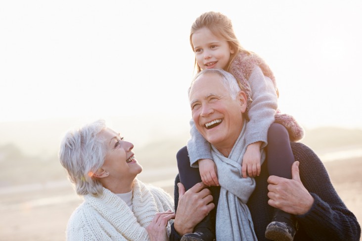 Grandparents and granddaughter at beach